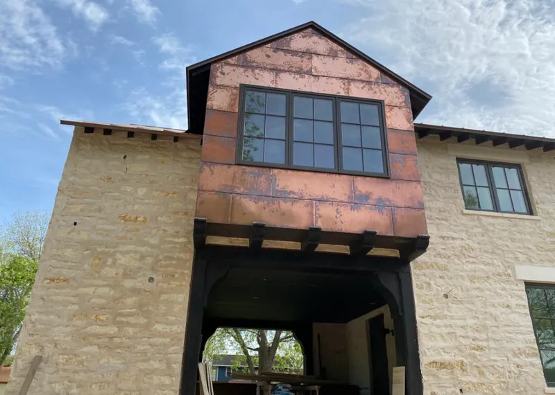 Copper metal panel facade on a stone building for Metal Roof Coating in Beaufort